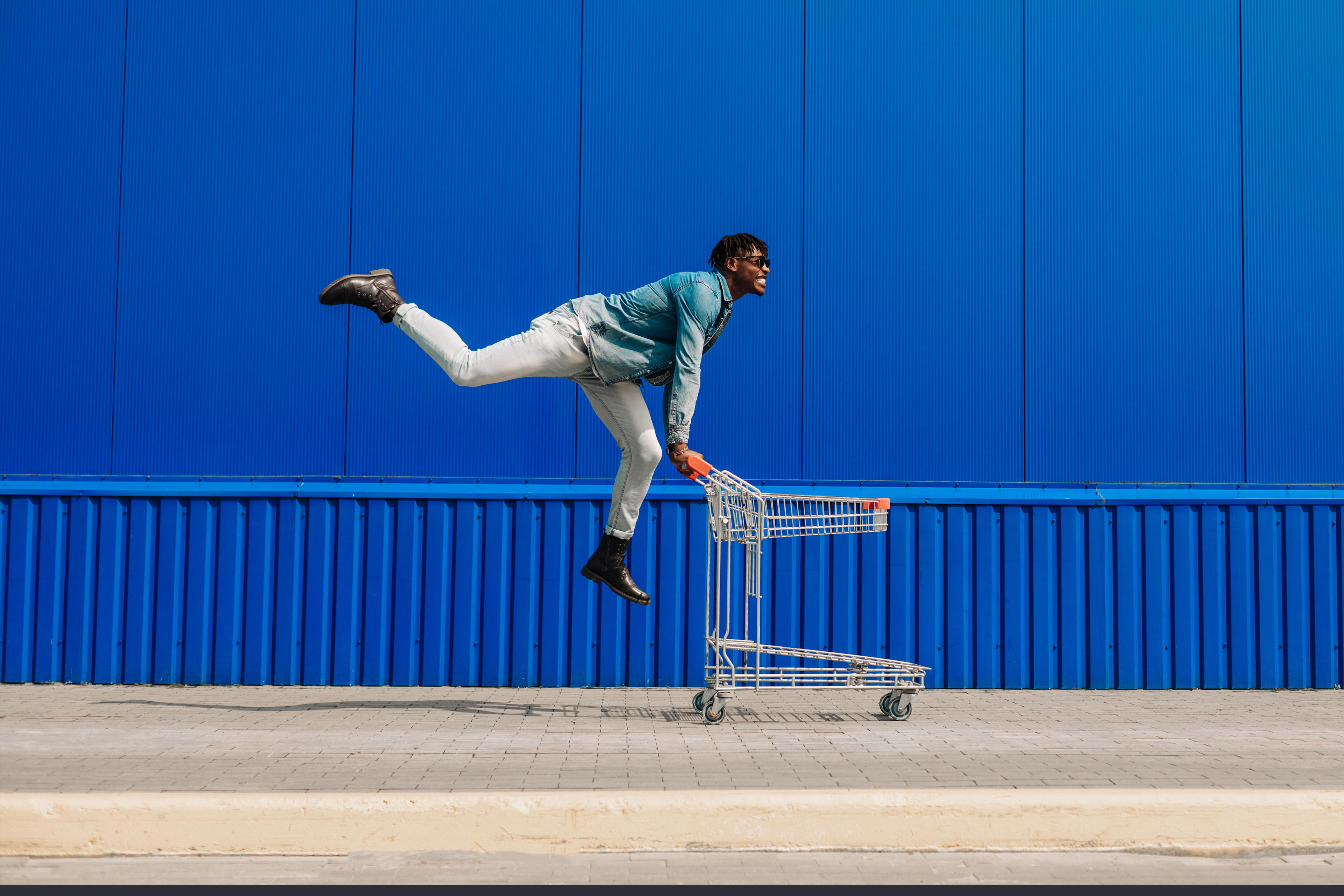 Man running with empty shopping cart